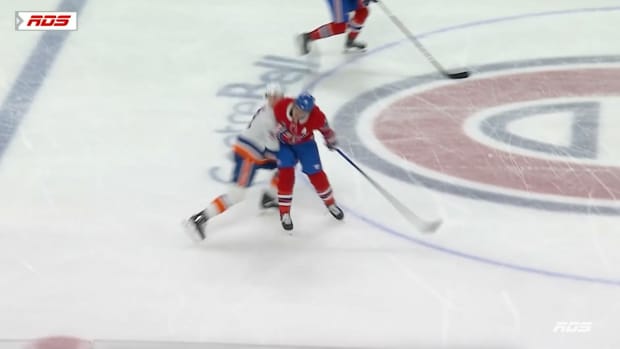 Brandon Gallagher hits Adam Pelech in the head with his elbow.